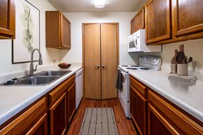 Altoona apartment for rent - A kitchen with wooden cabinets and a white counter top.