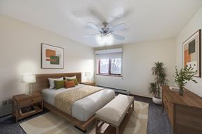 Altoona apartment for rent - A bedroom with a large bed and a ceiling fan.