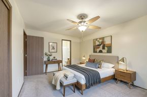 Altoona apartment for rent - A bedroom with a bed, nightstand, and a ceiling fan.