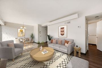 Prairie Village apartment for rent - A living room with a grey couch, a coffee table, and a painting on the wall.
