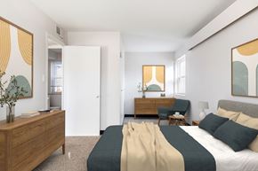 Prairie Village apartment for rent - A bedroom with a bed, nightstand, and chair.
