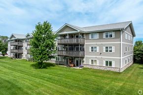 Grimes apartment for rent - A large two-story building with a balcony on the second floor.