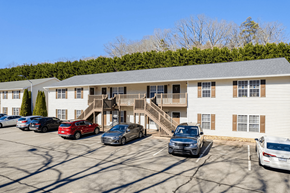Asheville apartment for rent - a parking lot with cars in front of an apartment building