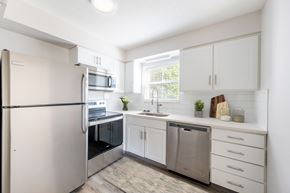 Prairie Village apartment for rent - A modern kitchen with white cabinets and stainless steel appliances.