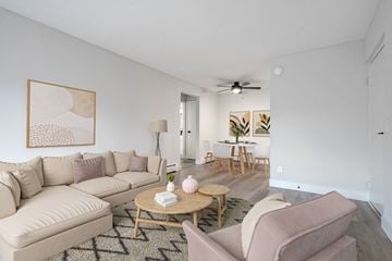 Cincinnati apartment for rent - A living room with a beige couch, a coffee table, and a painting on the wall.
