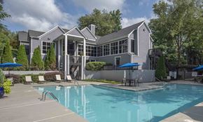 Roswell apartment for rent - A large house with a pool in front.