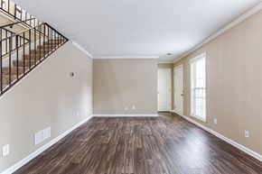 Peachtree Corners apartment for rent - an empty living room with wood flooring and a staircase
