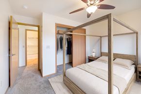 Grimes apartment for rent - A bedroom with a large bed and a ceiling fan.