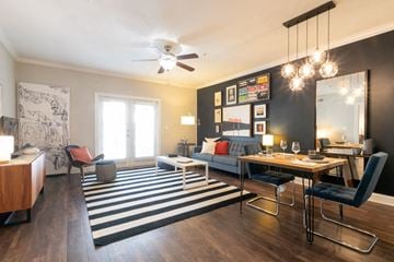 Atlanta apartment for rent - a living room with a dining room table and a ceiling fan
