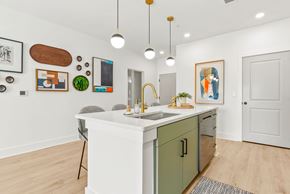 Arden apartment for rent - A kitchen with a white counter and green cabinets.