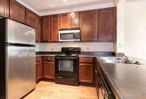 Beaumont apartment for rent - a kitchen with wooden cabinets and stainless steel appliances