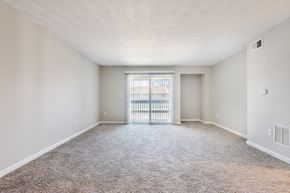 Indianapolis apartment for rent - an empty living room with a door to a balcony