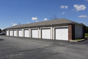 Indianapolis apartment for rent - a row of garages with white doors and a brick building
