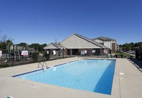 Indianapolis apartment for rent - a swimming pool with a house in the background