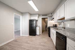 Columbus apartment for rent - a kitchen with white cabinets and a black refrigerator