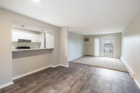 Madison apartment for rent - an empty living room and kitchen with wood flooring