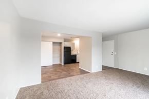 Madison apartment for rent - an empty living room with a kitchen in the background