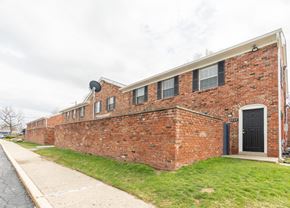 Indianapolis apartment for rent - the side of a brick building with a black door