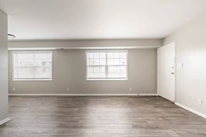 Indianapolis apartment for rent - an empty living room with a door and two windows