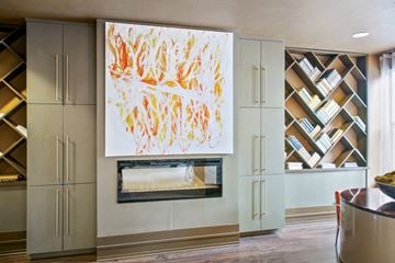 Birmingham apartment for rent - a painting hangs above a fireplace in a living room