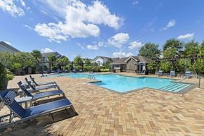Prattville apartment for rent - a resort style pool with blue lounge chairs around it at Century HomePlace, Prattville, AL