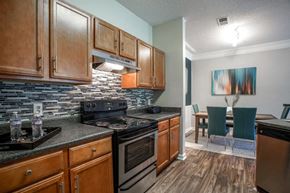 College Park apartment for rent - a kitchen with stainless steel appliances and wooden cabinets