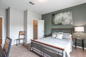 College Park apartment for rent - a bedroom with a bed and a painting on the wall