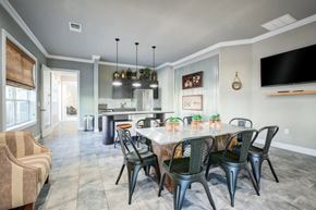 Lakeland apartment for rent - A dining room with a table set for six and a television mounted on the wall.at Century Ariva, Florida