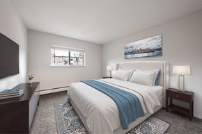 Cincinnati apartment for rent - A bedroom with a large bed and a painting on the wall.