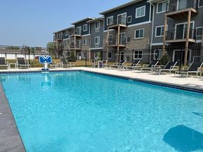 Altoona apartment for rent - A swimming pool in front of apartment buildings.