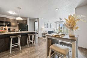 Altoona apartment for rent - A kitchen with a bar area and a dining table with chairs.