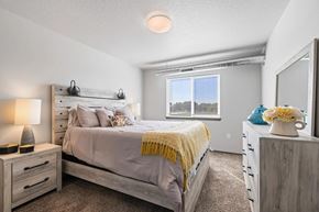 Altoona apartment for rent - A bedroom with a bed, nightstands, and a window.