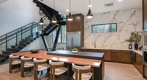 Jacksonville apartment for rent - A modern kitchen with a marble backsplash and a wooden dining table with chairs.