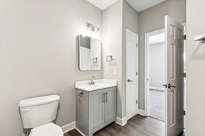 Goose Creek apartment for rent - A white toilet sits next to a sink in a bathroom.