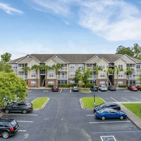 Moncks Corner apartment for rent - A parking lot in front of a building with cars parked.