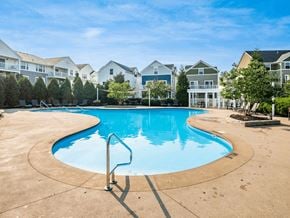 Columbus apartment for rent - A swimming pool in a residential area with houses in the background.