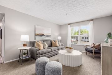 Gahanna apartment for rent - A living room with a grey couch, a white coffee table, and a painting on the wall.