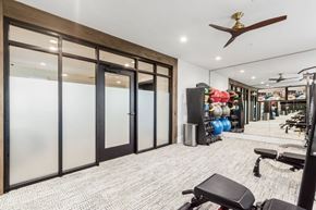Columbus apartment for rent - A gym with a bench, weights, and a fan.