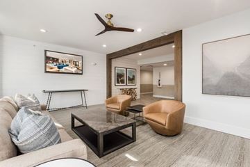 Columbus apartment for rent - A living room with a grey couch, a coffee table, and a painting on the wall.