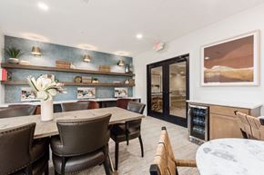 Columbus apartment for rent - A dining room with brown chairs and a table with a vase of flowers on it.