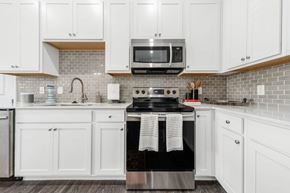 Lewis Center apartment for rent - A kitchen with white cabinets and a black stove top.