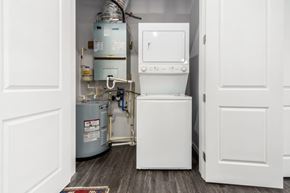 Lewis Center apartment for rent - A white tankless water heater sits in a narrow space between two doors.