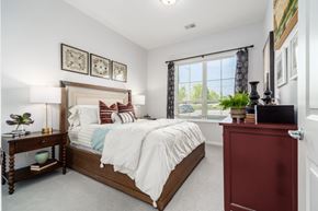 Lewis Center apartment for rent - A bedroom with a large bed and a red dresser.