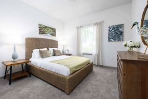 Savannah apartment for rent - A bedroom with a large bed and a wooden nightstand.