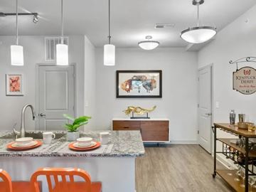 Louisville apartment for rent - A kitchen with a table set for two and a painting of a horse on the wall.