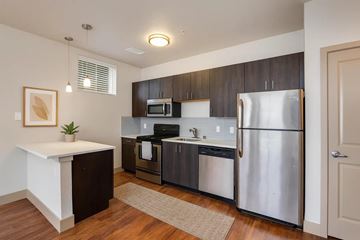 Denver apartment for rent - A kitchen with a refrigerator, microwave, and oven.
