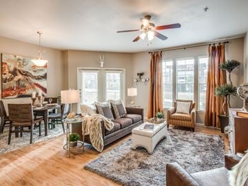 Keller apartment for rent - A living room with a brown couch, a white coffee table, and a painting on the wall.