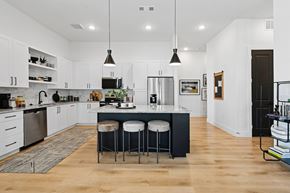 Euless apartment for rent - A kitchen with a bar stool and a counter.