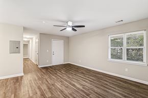 East Ridge apartment for rent - A room with a ceiling fan and a window with a view of trees.