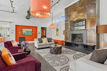 Columbus apartment for rent - A living room with a fireplace and a painting on the wall.